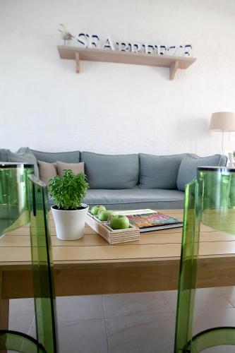 a living room with a couch and a table at Skopelos Village Hotel in Skopelos Town