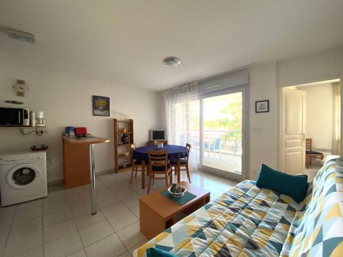 un salon avec un canapé et une table dans l'établissement Vaux-sur-Mer : Appartement 2* avec piscine et balcon - FR-1-738-39, à Vaux-sur-Mer