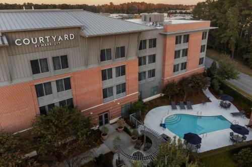 an aerial view of a building with a pool at Courtyard by Marriott Charleston Summerville in Summerville