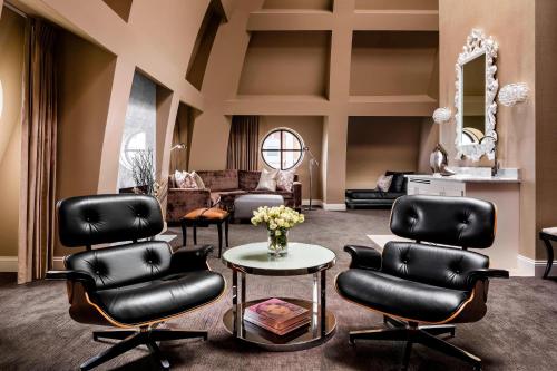 a salon with black leather chairs and a table at The Blackstone, Autograph Collection in Chicago