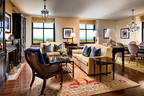 a living room with a couch and a table at The Blackstone, Autograph Collection in Chicago