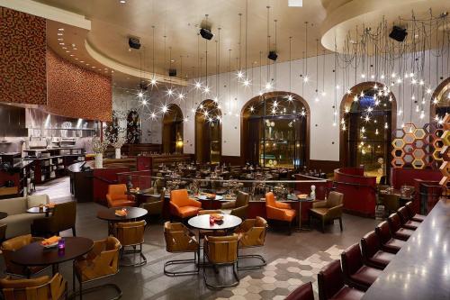 a restaurant with tables and chairs and a bar at The Blackstone, Autograph Collection in Chicago