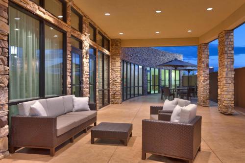 a living room with two chairs and a table at Courtyard by Marriott Denver North/Westminster in Eastlake