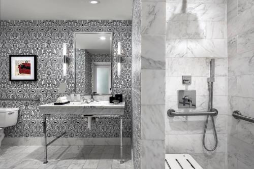 a bathroom with a sink and a mirror at The Blackstone, Autograph Collection in Chicago