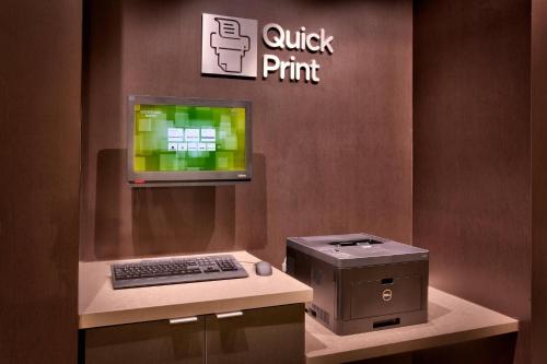 a display of a computer and a printer on a counter at Courtyard by Marriott Denver North/Westminster in Eastlake