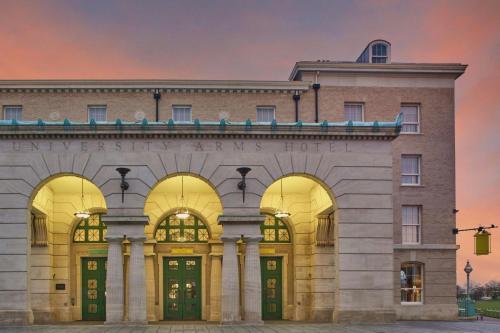a large brick building with arches on it at University Arms, Autograph Collection in Cambridge