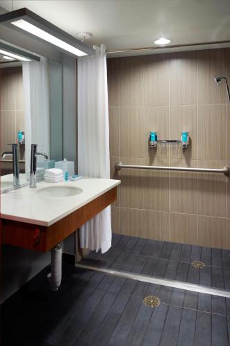 a bathroom with a sink and a shower at Aloft Atlanta Downtown in Atlanta