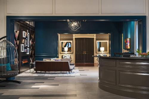 a lobby with a bird cage and a table at The Lindy Renaissance Charleston Hotel in Charleston