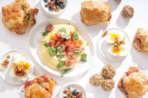 a table with plates of breakfast foods on it at The Lindy Renaissance Charleston Hotel in Charleston