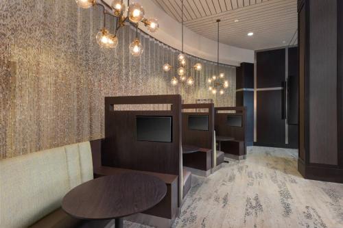 a room with a row of televisions on a wall at Courtyard by Marriott Greenville Downtown in Greenville