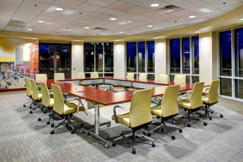 a conference room with a large table and chairs at Courtyard by Marriott Greenville Downtown in Greenville