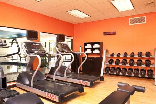 a gym with three tread machines in a room at Courtyard Hartford Manchester in Manchester