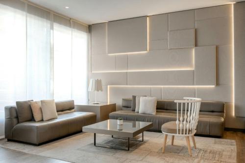 a living room with a couch and a table at AC Hotel San Cugat by Marriott in Sant Cugat del Vallès