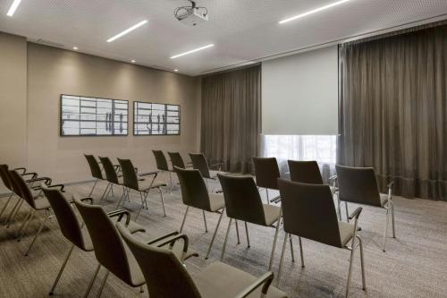 a conference room with chairs and a large window at AC Hotel San Cugat by Marriott in Sant Cugat del Vallès