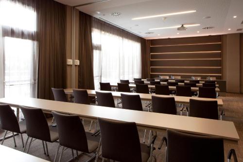a conference room with a long table and chairs at AC Hotel San Cugat by Marriott in Sant Cugat del Vallès