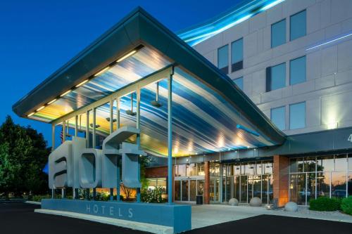 a building with a hotel sign in front of it at aloft Green Bay in Green Bay