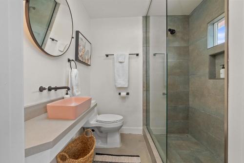 a bathroom with a shower and a toilet and a mirror at Peaceful Desert Escape with Pool, Fire Pit and Stargazing Views in Yucca Valley