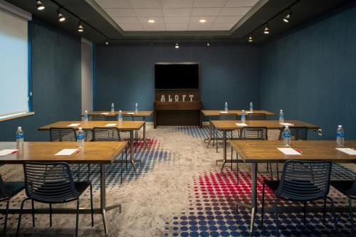 a conference room with tables and a podium in the background at aloft Green Bay in Green Bay