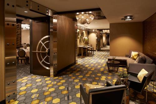 a lobby with a waiting room with couches and tables at Metropolitan at The 9, Autograph Collection in Cleveland