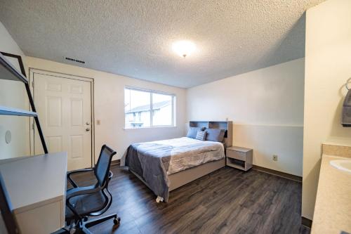 a bedroom with a bed and a desk and a chair at WSU HomeBase - Where Comfort Meets Convenience in Pullman