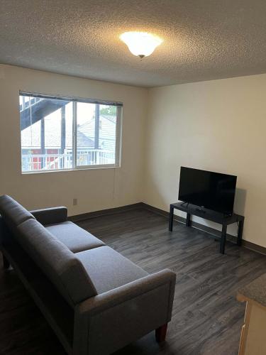 a living room with a couch and a flat screen tv at WSU HomeBase - Where Comfort Meets Convenience in Pullman