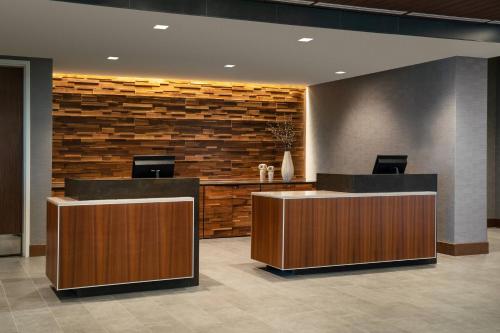 a lobby with two reception desks and a brick wall at Courtyard by Marriott Loveland Fort Collins in Loveland