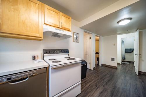 a kitchen with a stove and wooden cabinets at WSU HomeBase - Where Comfort Meets Convenience in Pullman
