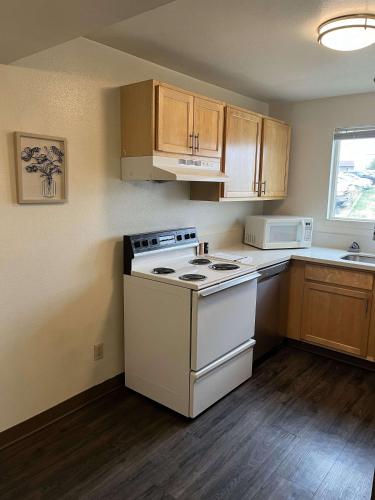 a kitchen with a white stove and a microwave at WSU HomeBase - Where Comfort Meets Convenience in Pullman