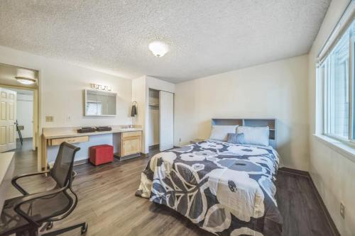 a bedroom with a bed and a desk and a chair at WSU HomeBase - Where Comfort Meets Convenience in Pullman