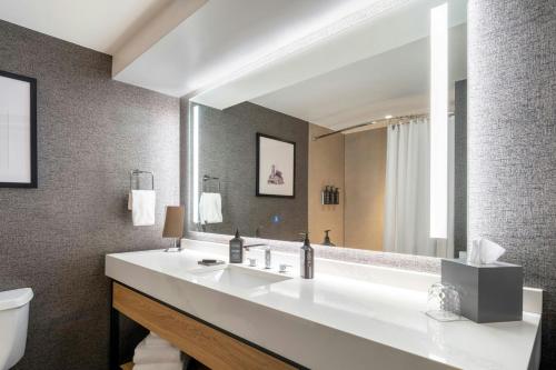 a bathroom with a sink and a large mirror at Sheraton Nashville Brentwood in Brentwood