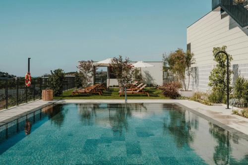 a swimming pool in the middle of a building at Sabàtic Sitges Hotel, Autograph Collection in Sitges