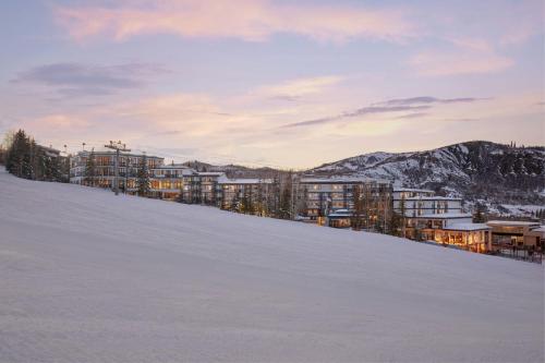 a building on a snowy hill in the snow at Viewline Resort Snowmass, Autograph Collection in Snowmass Village