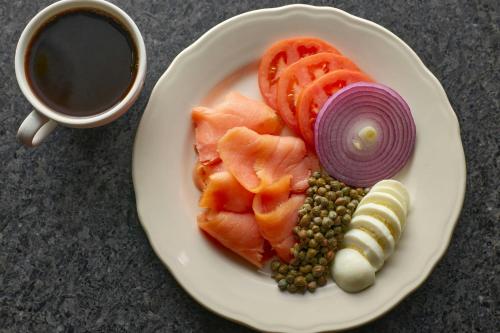 a plate of food with vegetables and a cup of coffee at Viewline Resort Snowmass, Autograph Collection in Snowmass Village