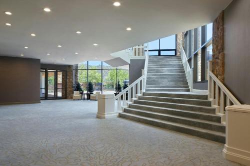 a lobby of a building with stairs and windows at Viewline Resort Snowmass, Autograph Collection in Snowmass Village