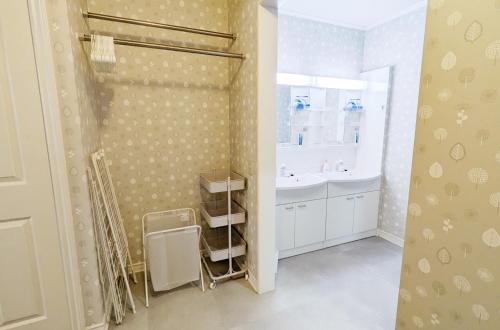 a bathroom with a shower and a sink and a tub at Soen 1996 Villa in Sapporo