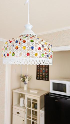 a colorful umbrella in a kitchen next to a microwave at Soen 1996 Villa in Sapporo