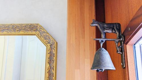a bell hanging on a door next to a mirror at Soen 1996 Villa in Sapporo