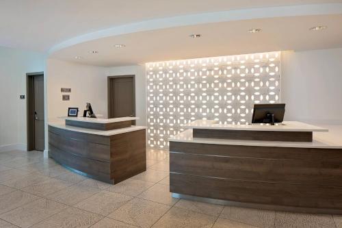 a lobby with a reception desk and a wall with lights at Residence Inn by Marriott Charleston Summerville in Summerville