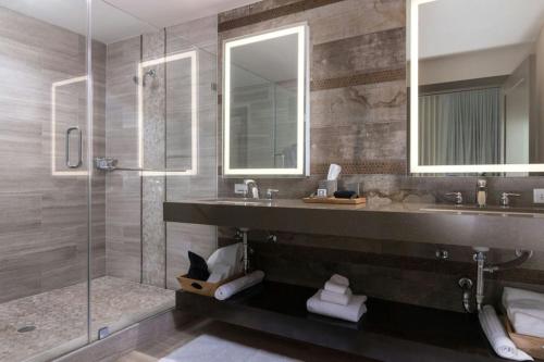 a bathroom with a sink and a shower at The Stella Hotel, Autograph Collection in Bryan