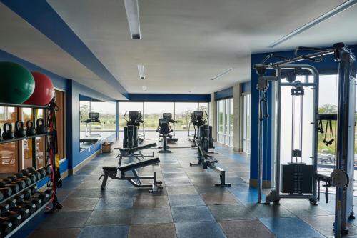 a gym with several tread machines in a room at The Stella Hotel, Autograph Collection in Bryan