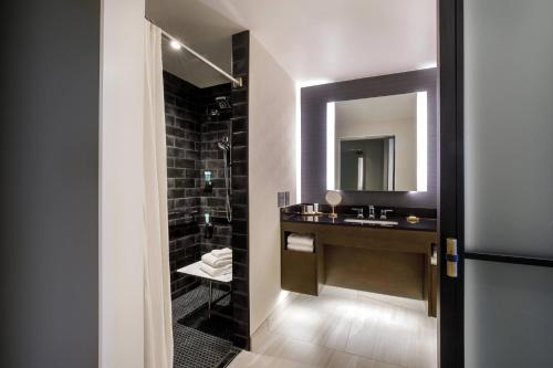 a bathroom with a sink and a mirror at Hotel Vin, Autograph Collection in Grapevine