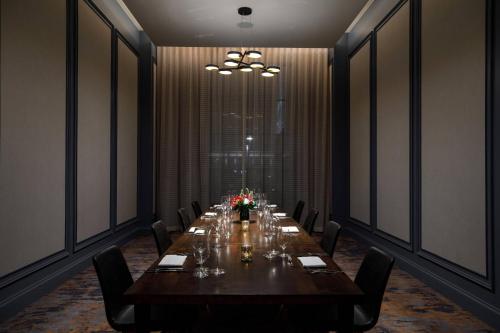 a long dining room with a long table and chairs at Hotel Vin, Autograph Collection in Grapevine