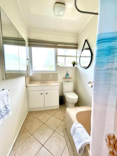 a bathroom with a tub and a toilet and a sink at Home in Somers in Somers