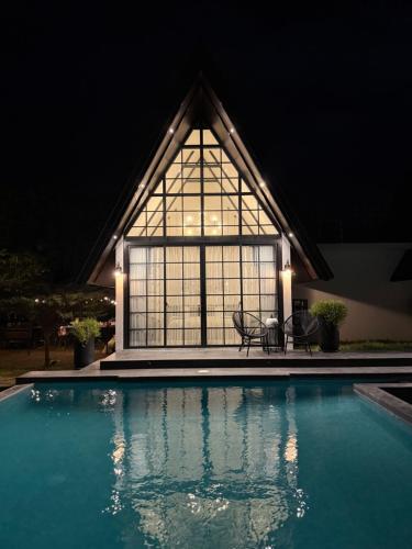 a house with a swimming pool with a large window at Las Villas De La Serenidad in Calatagan