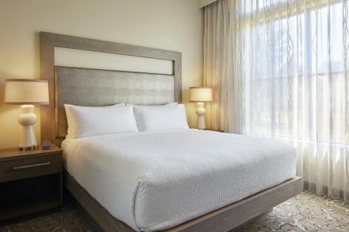 a bedroom with a large bed and a large window at Andell Inn in Kiawah Island