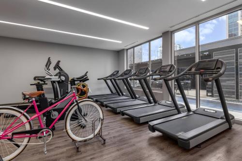 a gym with a row of bikes and treadmills at AC Hotel by Marriott Atlanta Midtown in Atlanta