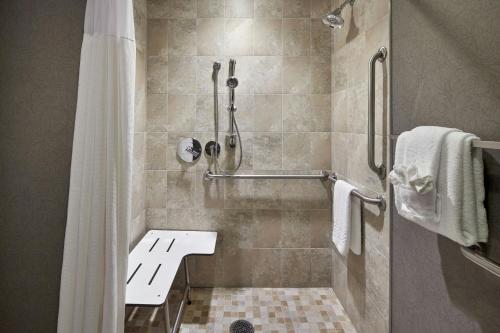 a bathroom with a shower with a shower curtain at Andell Inn in Kiawah Island