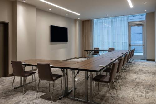 a conference room with a long table and chairs at AC Hotel by Marriott Atlanta Midtown in Atlanta