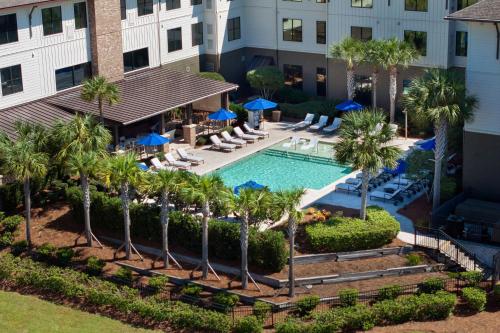 an aerial view of the pool at a hotel with palm trees at Andell Inn in Kiawah Island