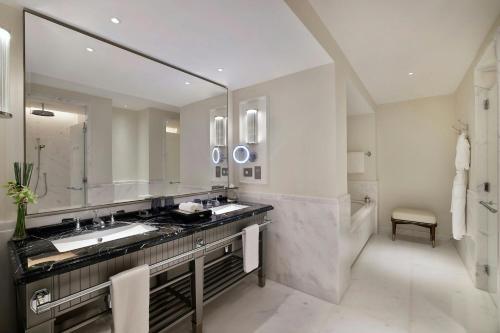 a bathroom with a sink and a large mirror at The Ritz-Carlton, Amman in Amman